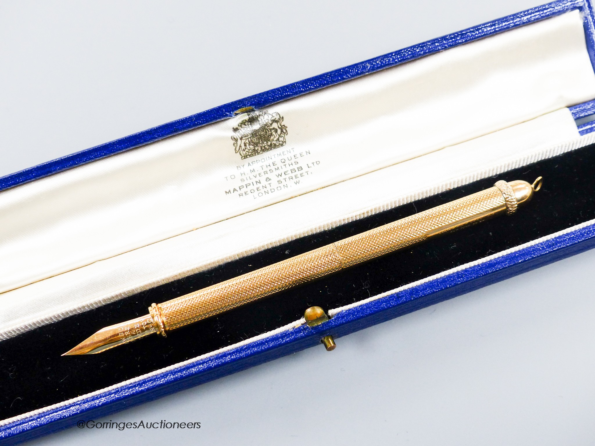 A 1960's engine turned 18k overlaid dip pen, with engraved inscription, 12.9cm, gross weight 24.4 grams.
